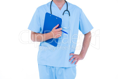 Standing young nurse in blue tunic
