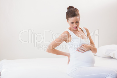 Pregnancy sitting on the bed