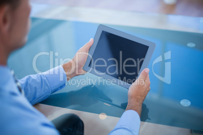 Businessman using his tablet