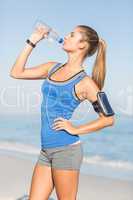 Portrait of beautiful fit woman drinking water