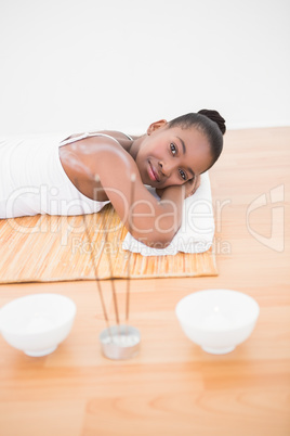 Peaceful pretty woman lying a bamboo mat