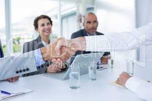 Interview panel shaking hands with applicant