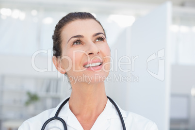 Smiling doctor looking at top