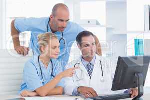 Doctors and surgeon working with computer