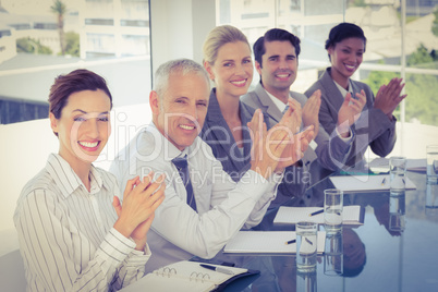 Business team applauding during conference