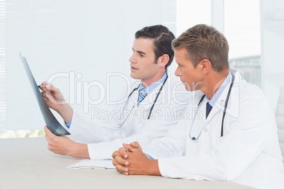 Concentrated doctors looking at Xray