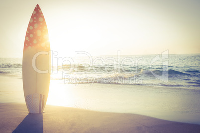 surf board standing on the sand