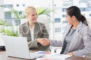 Businesswomen shaking hands