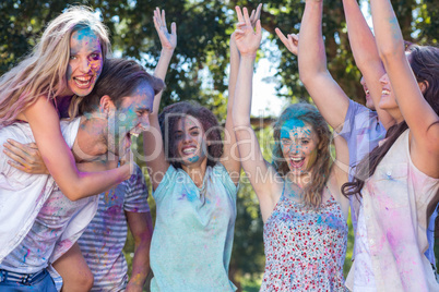 Happy friends covered in powder paint