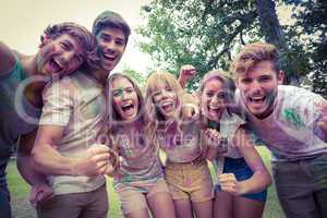 Happy friends throwing powder paint