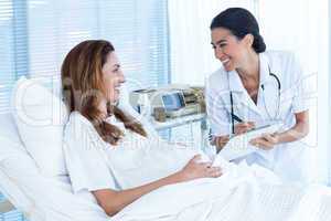 Smiling pregnant woman with her doctor