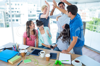 Young business people putting their hands together Young business people putting their hands together