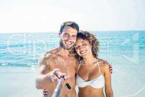Happy couple doing selfie with monopod