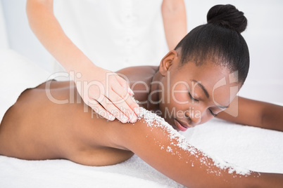 Pretty woman enjoying an exfoliation massage