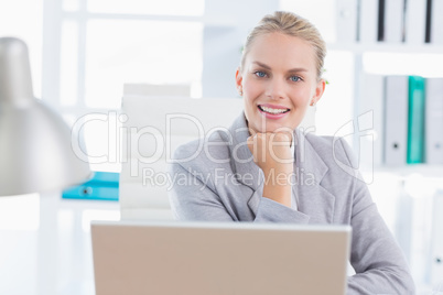 Smiling businesswoman using her computer