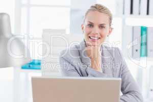 Smiling businesswoman using her computer