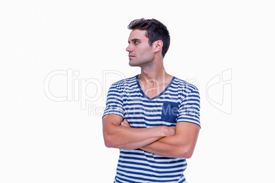 Handsome hipster looking away with arms crossed