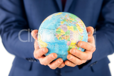 Hand of businessman holding terrestrial globe Hand of businessman holding terrestrial globe