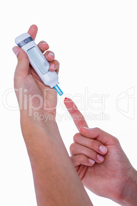 Diabetic woman using blood glucose monitor