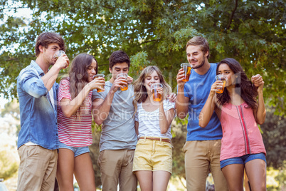 Happy friends in the park having picnic