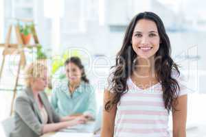 Smiling businesswoman with colleagues