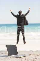 Happy businessman cheering in front of the sea