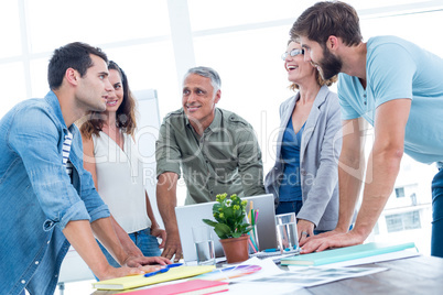 Casual colleagues using laptop in the office