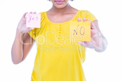 Pretty hipster holding yes and no sheets of paper