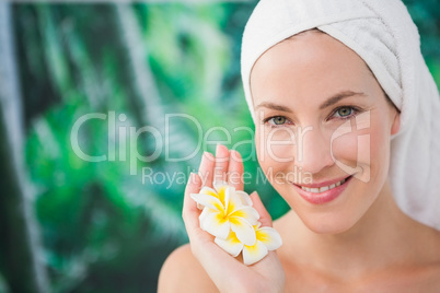 Close up of a beautiful young woman holding flower