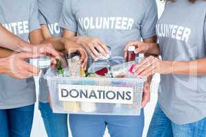 Volunteers friends separating donation stuffs