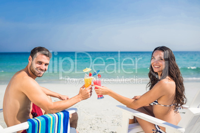 Happy couple drinking a cocktail together