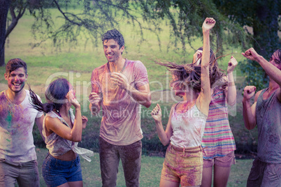 Happy friends covered in powder paint