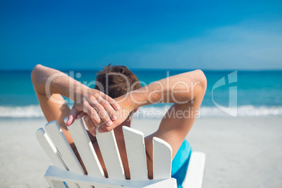 Man relaxing on deck chair at the beach