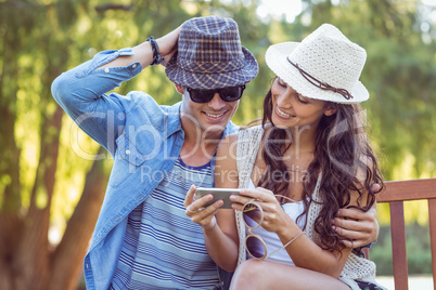 Cute couple looking at their selfies