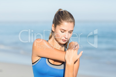 Beautiful fit woman stretching her arm