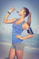 Fit woman drinking water