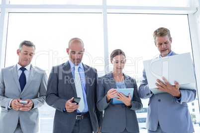 Business colleagues using their multimedia devices