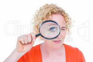 Pretty blonde looking at magnifying glass