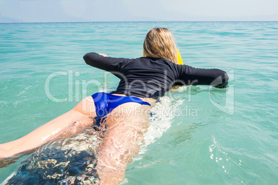 Woman with a surfboard on a sunny day