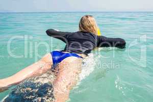 Woman with a surfboard on a sunny day