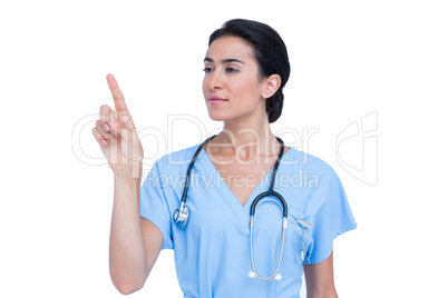 Young nurse in blue tunic pointing