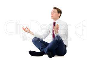Zen businessman meditating in yoga pose