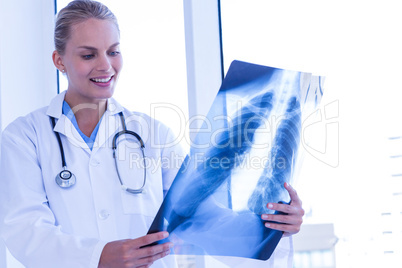 Smiling female doctor looking at Xray