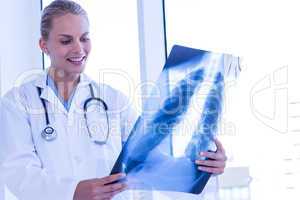 Smiling female doctor looking at Xray