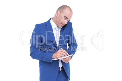 Young businessman writing on a notepad