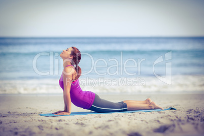 Brunette doing yoga on exercise mat