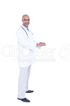 Confident doctor in white tunic writing notes