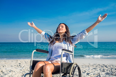 Disabled woman with arms outstretched at the beach