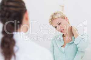 patient with neck pain visiting doctor