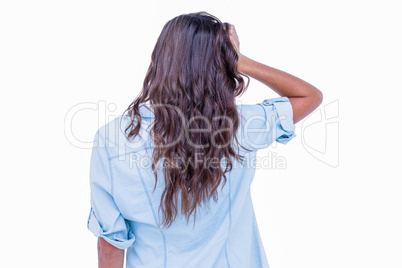 Rear view of pretty brunette with hand on head